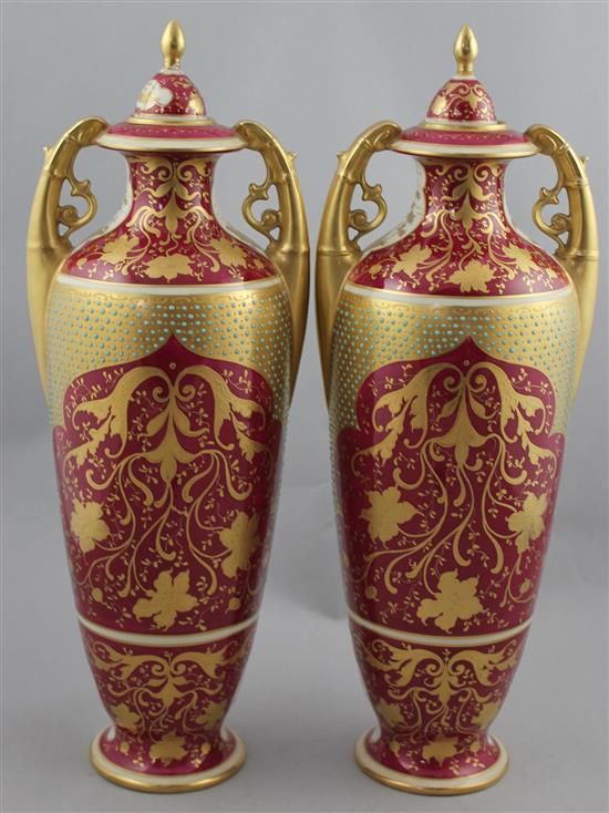 A pair of Vienna style porcelain twin handled vases and covers, c.1880-1900, 41.5cm, damages to cove